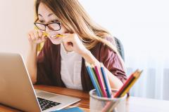 Woman reading from a laptop and looking surprised Woman reading from a laptop and looking surprised